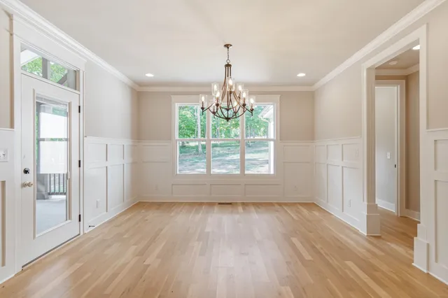 a view of a house with a small yard and wooden fence