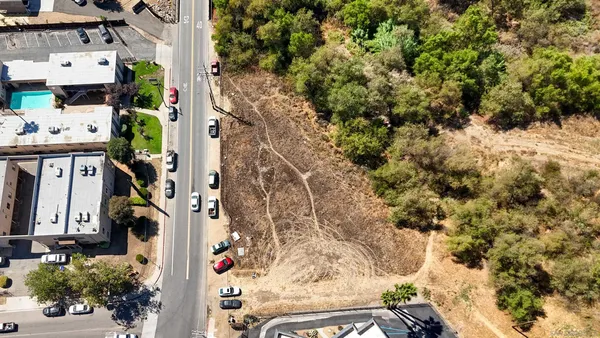 an aerial view of multi story residential apartment building with yard