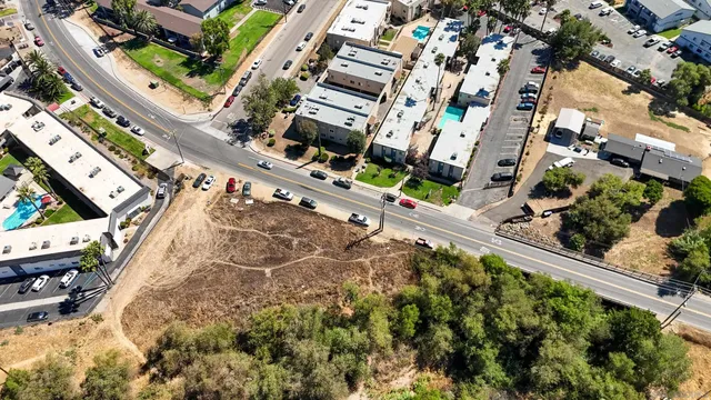 an aerial view of a residential apartment building with a yard