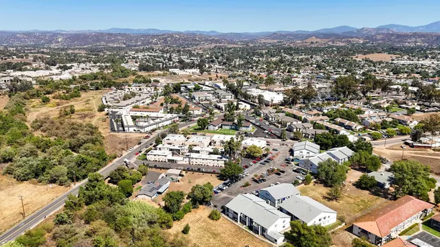an aerial view of residential houses with city view