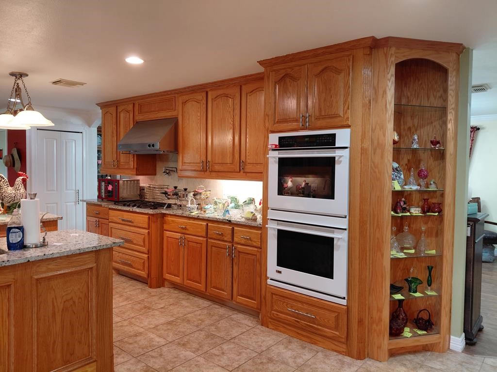 1231 County Road 201A Angleton, TX 77515 - Photo 26 of 26 a kitchen with sink cabinets and stainless steel appliances