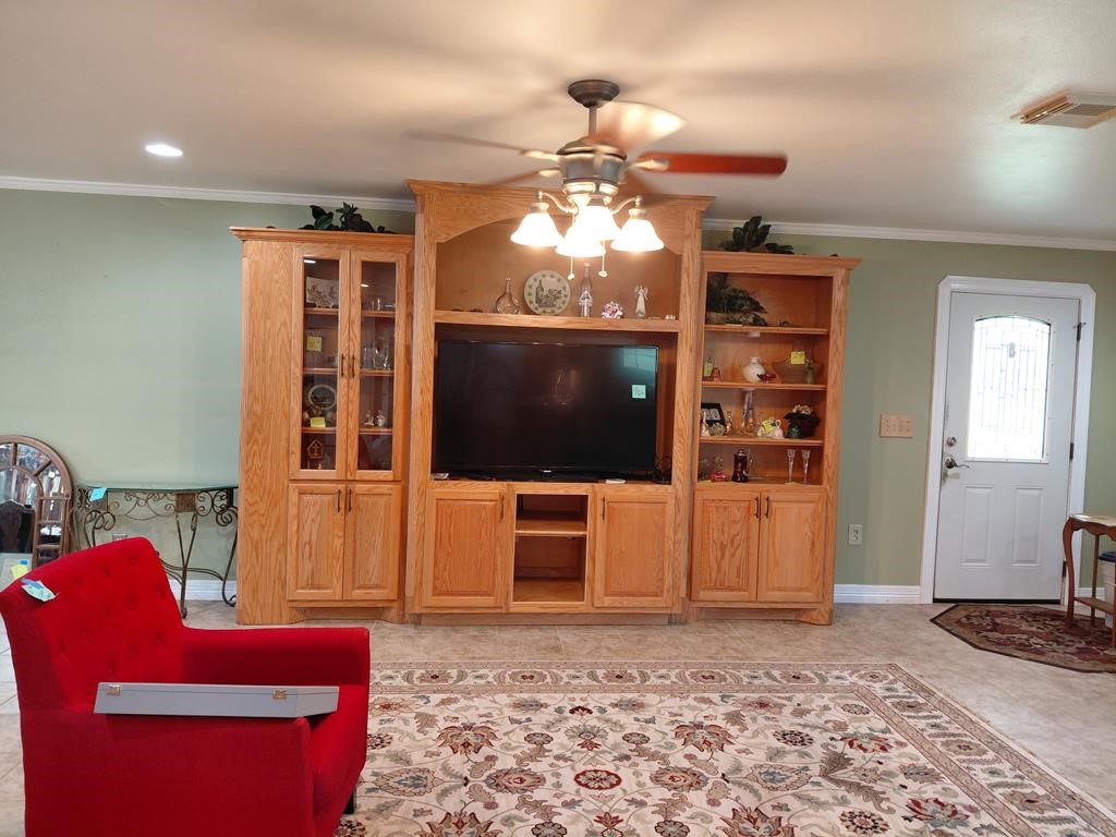 1231 County Road 201A Angleton, TX 77515 - Photo 9 of 26 a living room with furniture a flat screen tv and kitchen view