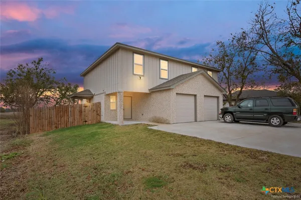 a view of a house with a yard and garage