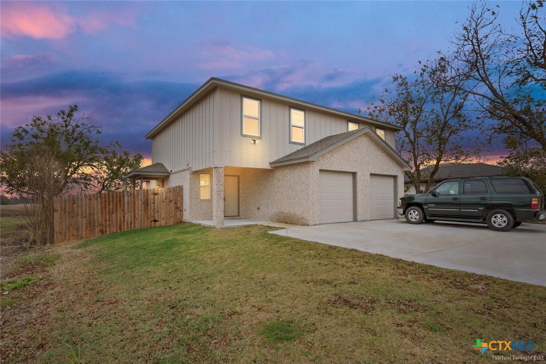 a view of a house with a yard and garage
