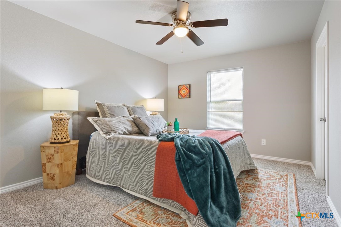 907 East Main Street, Unit A&B Troy, TX 76579 - Photo 14 of 28 a bed room with a bed and a chandelier