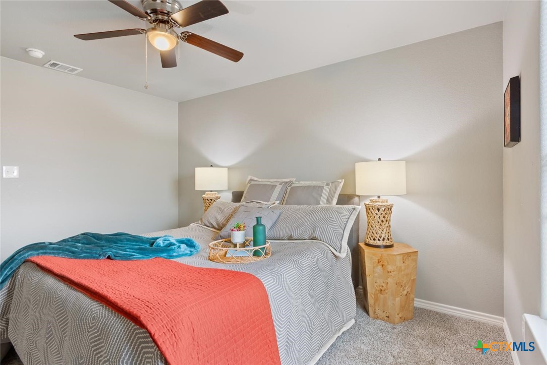 907 East Main Street, Unit A&B Troy, TX 76579 - Photo 15 of 28 a bedroom with a bed and a chandelier