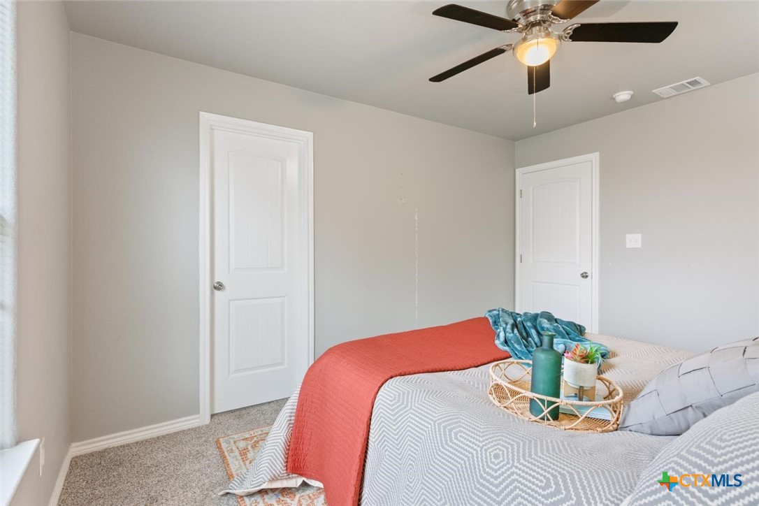 907 East Main Street, Unit A&B Troy, TX 76579 - Photo 16 of 28 a bedroom with a bed and a chandelier
