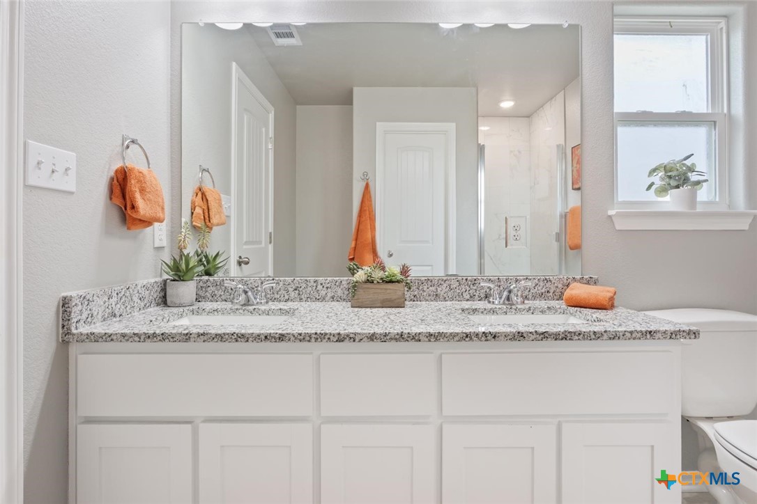 907 East Main Street, Unit A&B Troy, TX 76579 - Photo 17 of 28 a bathroom with a granite countertop sink and a mirror