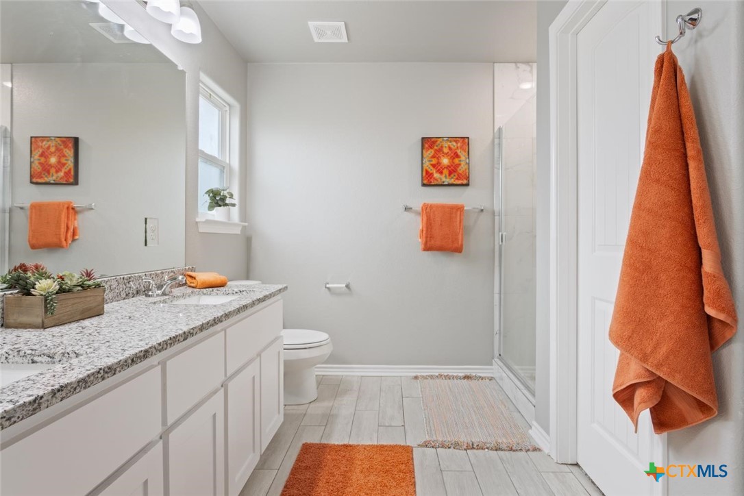 907 East Main Street, Unit A&B Troy, TX 76579 - Photo 18 of 28 a bathroom with a granite countertop sink and a mirror