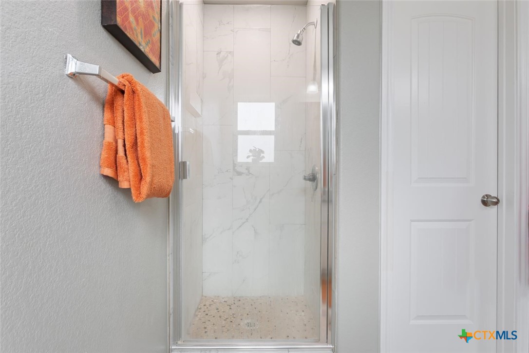907 East Main Street, Unit A&B Troy, TX 76579 - Photo 19 of 28 a bathroom with a shower and a mirror