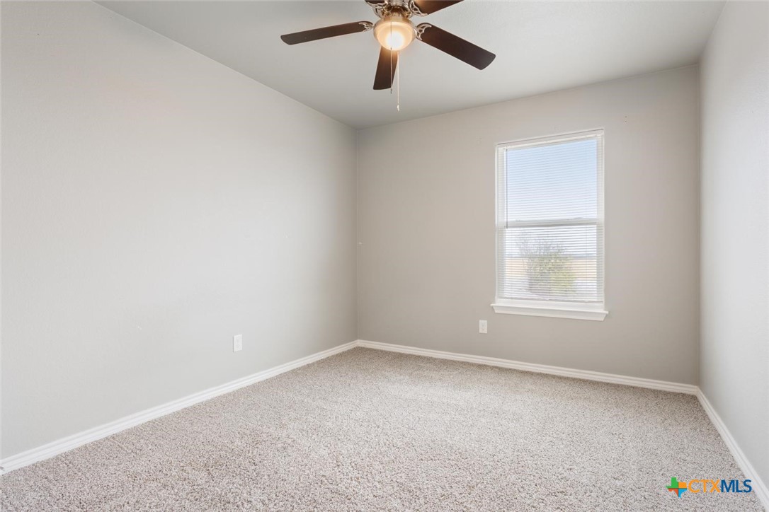 907 East Main Street, Unit A&B Troy, TX 76579 - Photo 21 of 28 an empty room with a window and a fan