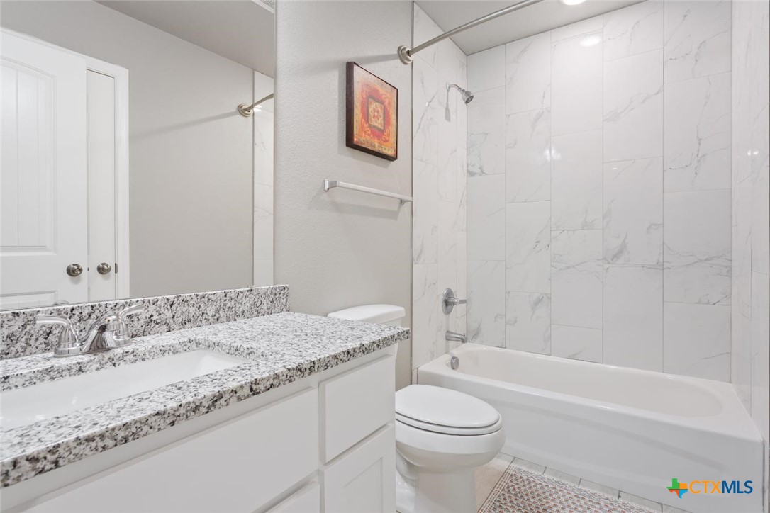 907 East Main Street, Unit A&B Troy, TX 76579 - Photo 23 of 28 a bathroom with a granite countertop sink toilet and shower