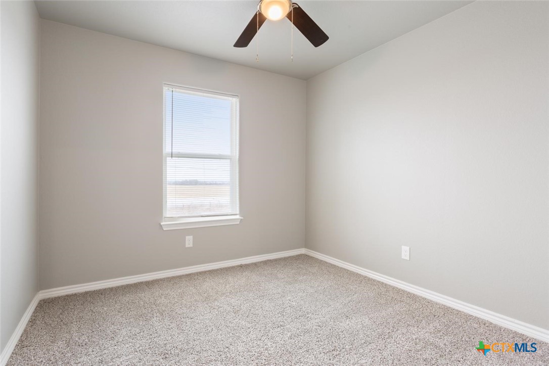 907 East Main Street, Unit A&B Troy, TX 76579 - Photo 24 of 28 an empty room with a window and a ceiling fan