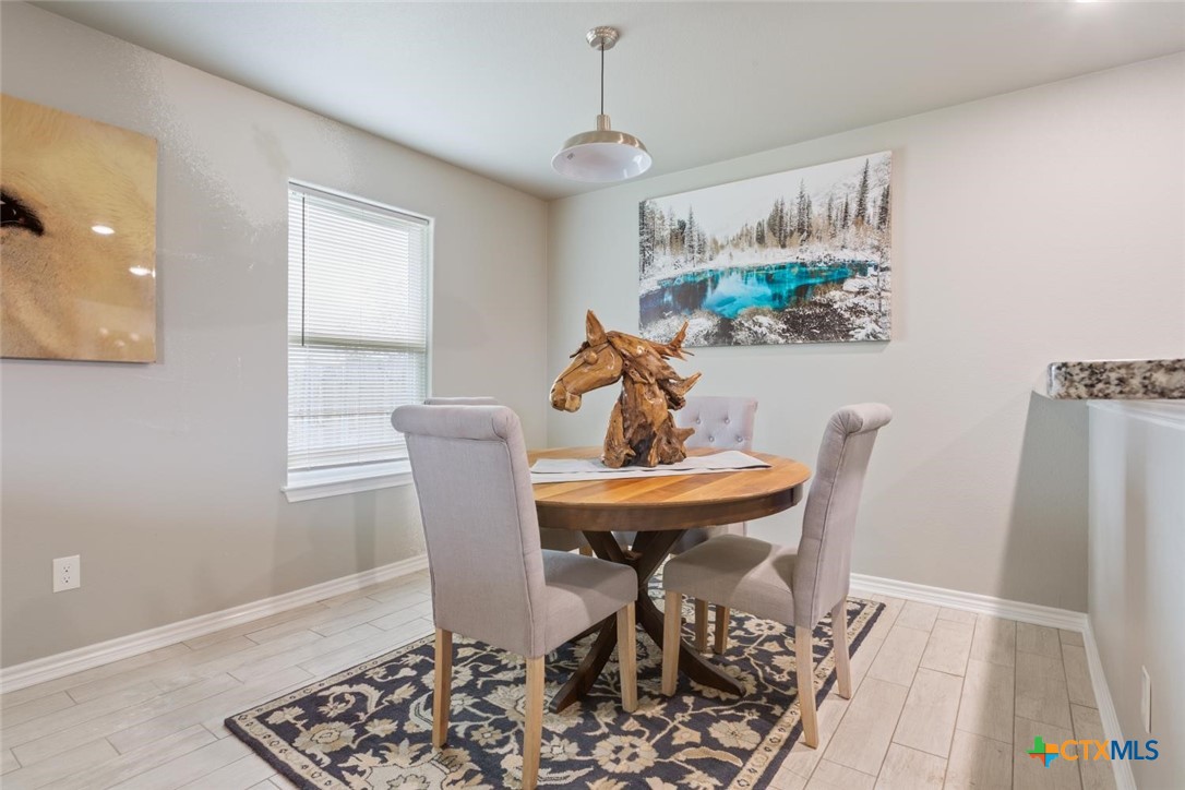 907 East Main Street, Unit A&B Troy, TX 76579 - Photo 7 of 28 a view of a dining room with furniture and wooden floor