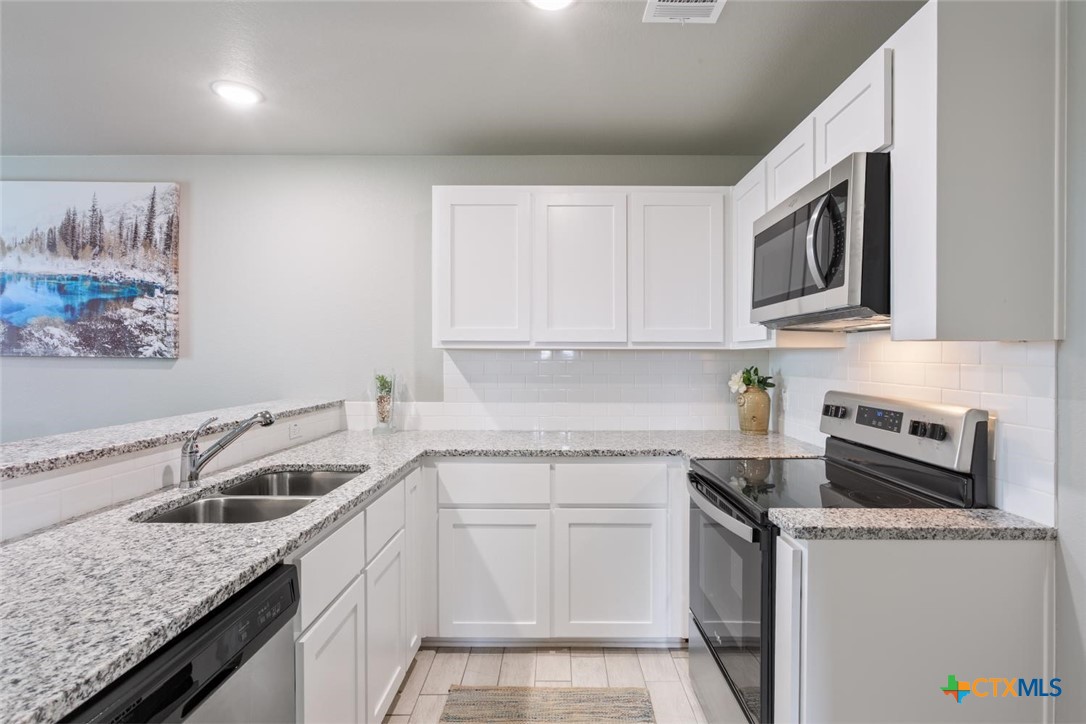 907 East Main Street, Unit A&B Troy, TX 76579 - Photo 9 of 28 a kitchen that has a sink and a stove