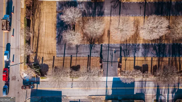 a front view of a house with garden space and trees