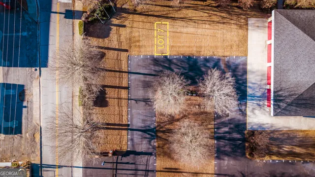 a front view of a house with cars parked
