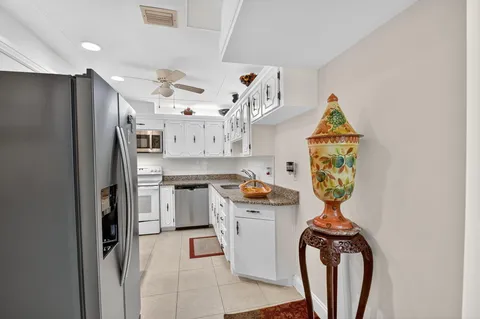 a kitchen with stainless steel appliances granite countertop a refrigerator and a stove