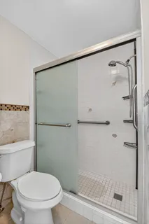 a bathroom with a sink vanity granite tub shower and a mirror
