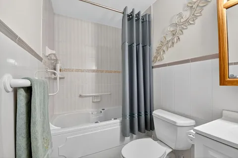a bathroom with a toilet sink and mirror