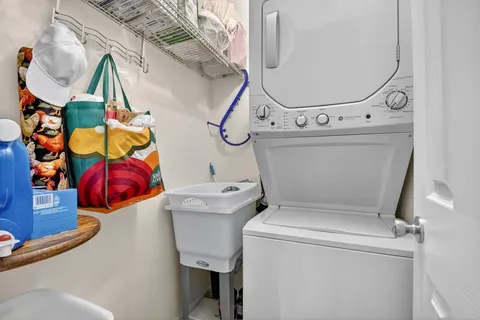 an aerial view of a house with a yard and lake view