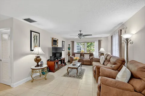 a living room with furniture fireplace and a large window