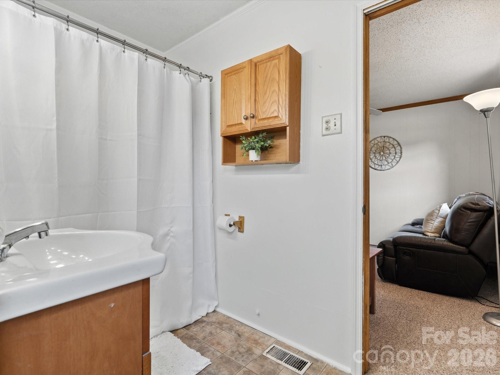 2212 J B Denton Road Lancaster, SC 29720 - Photo 11 of 38 a bathroom with a sink and a mirror