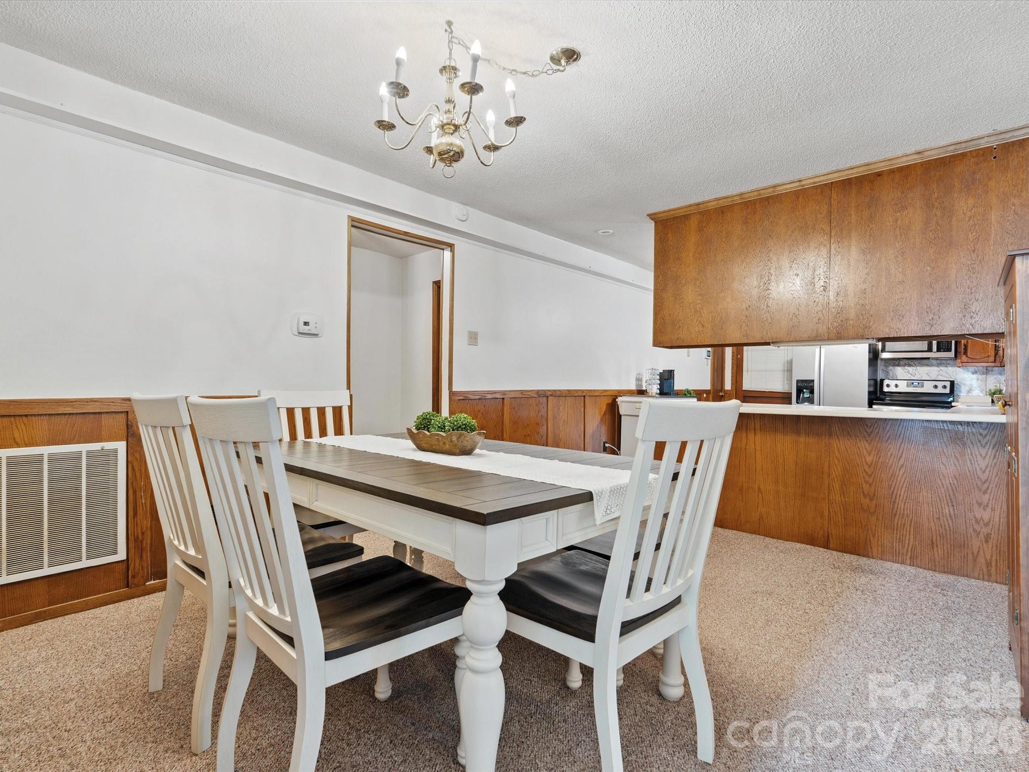 2212 J B Denton Road Lancaster, SC 29720 - Photo 18 of 38 a view of a dining room with furniture and wooden floor