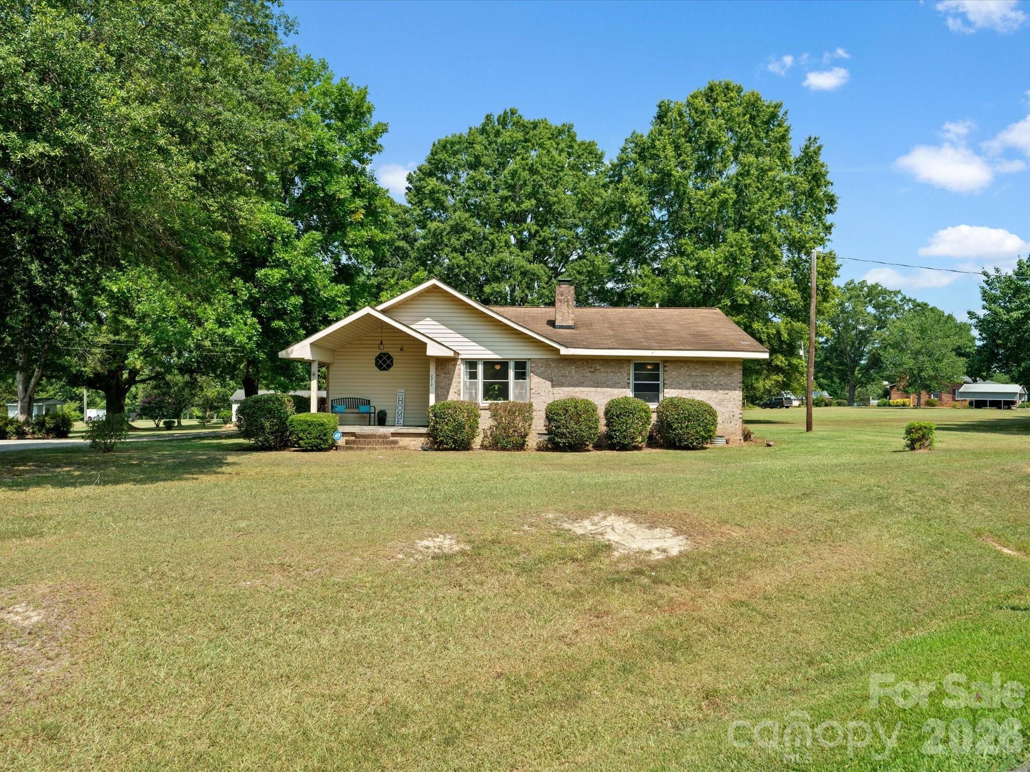 2212 J B Denton Road Lancaster, SC 29720 - Photo 2 of 38 a front view of a house with a yard and trees