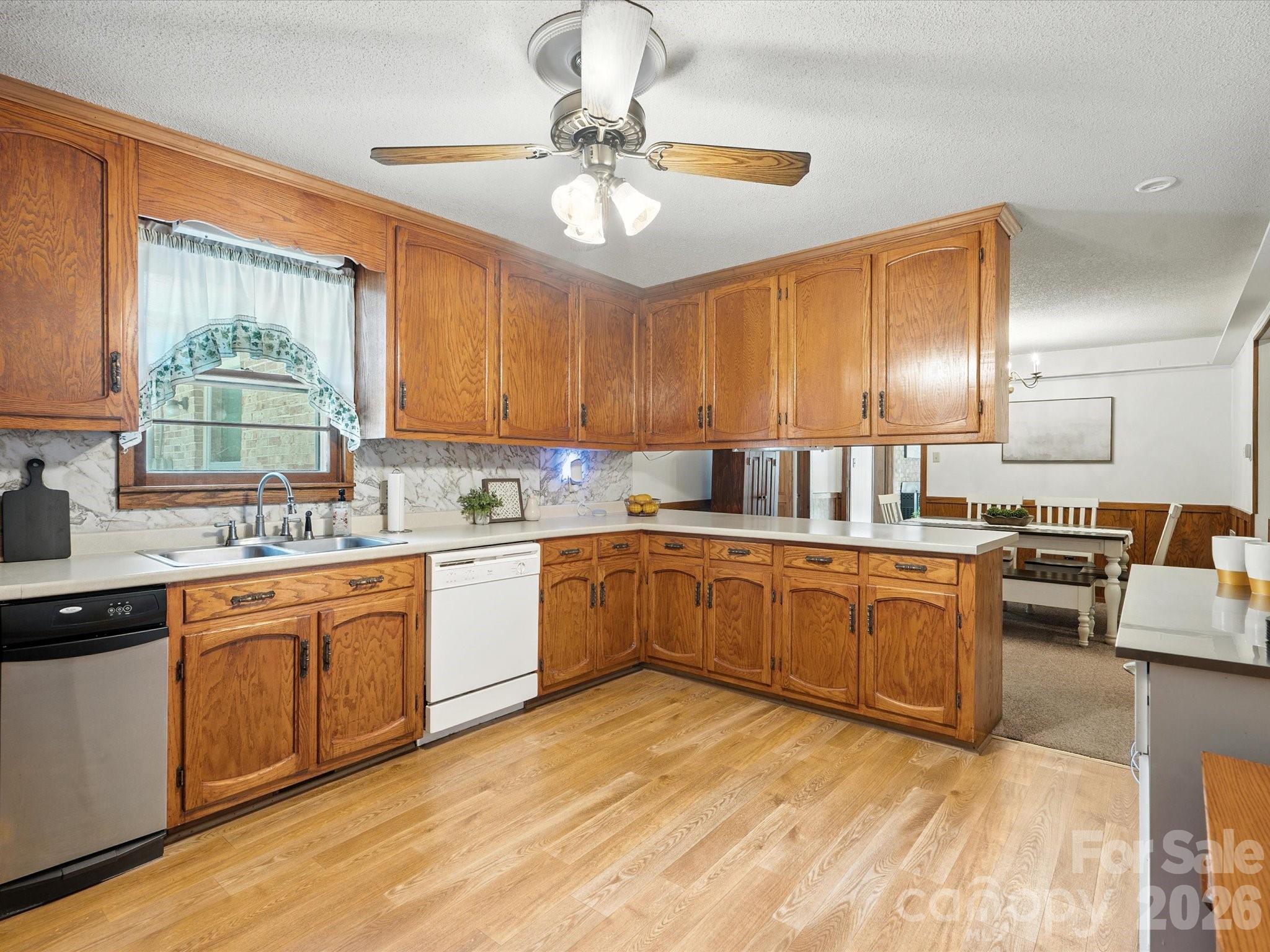2212 J B Denton Road Lancaster, SC 29720 - Photo 22 of 38 a kitchen with stainless steel appliances granite countertop a sink cabinets and window