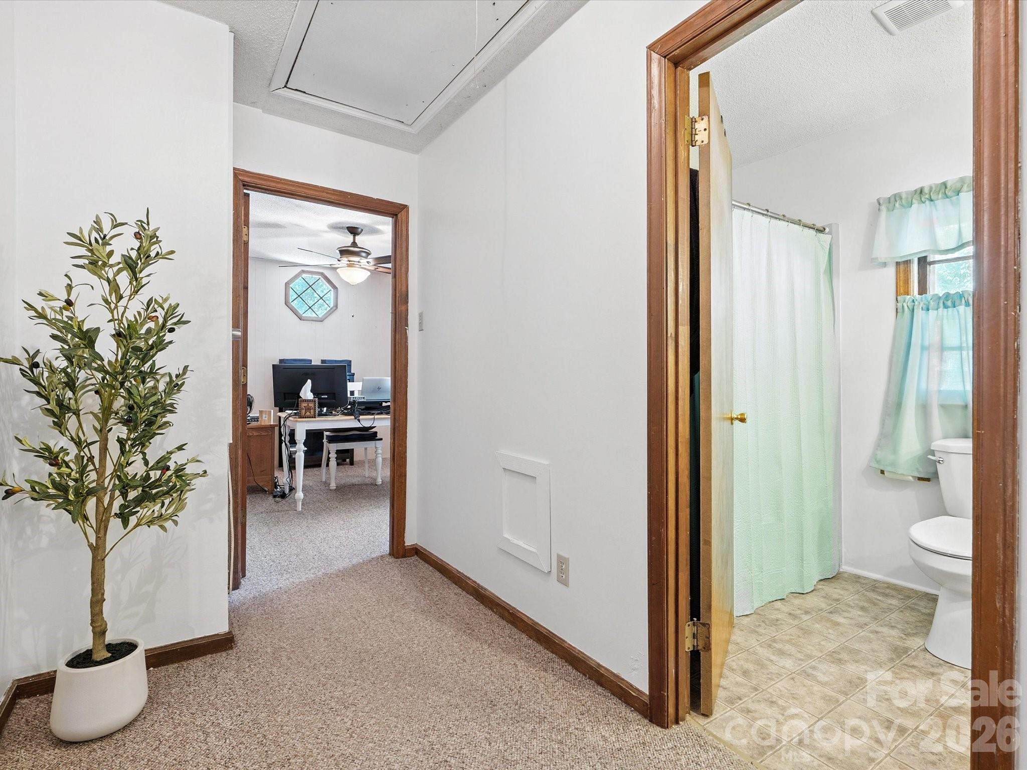 2212 J B Denton Road Lancaster, SC 29720 - Photo 24 of 38 a view of a hallway with dining room and wooden door