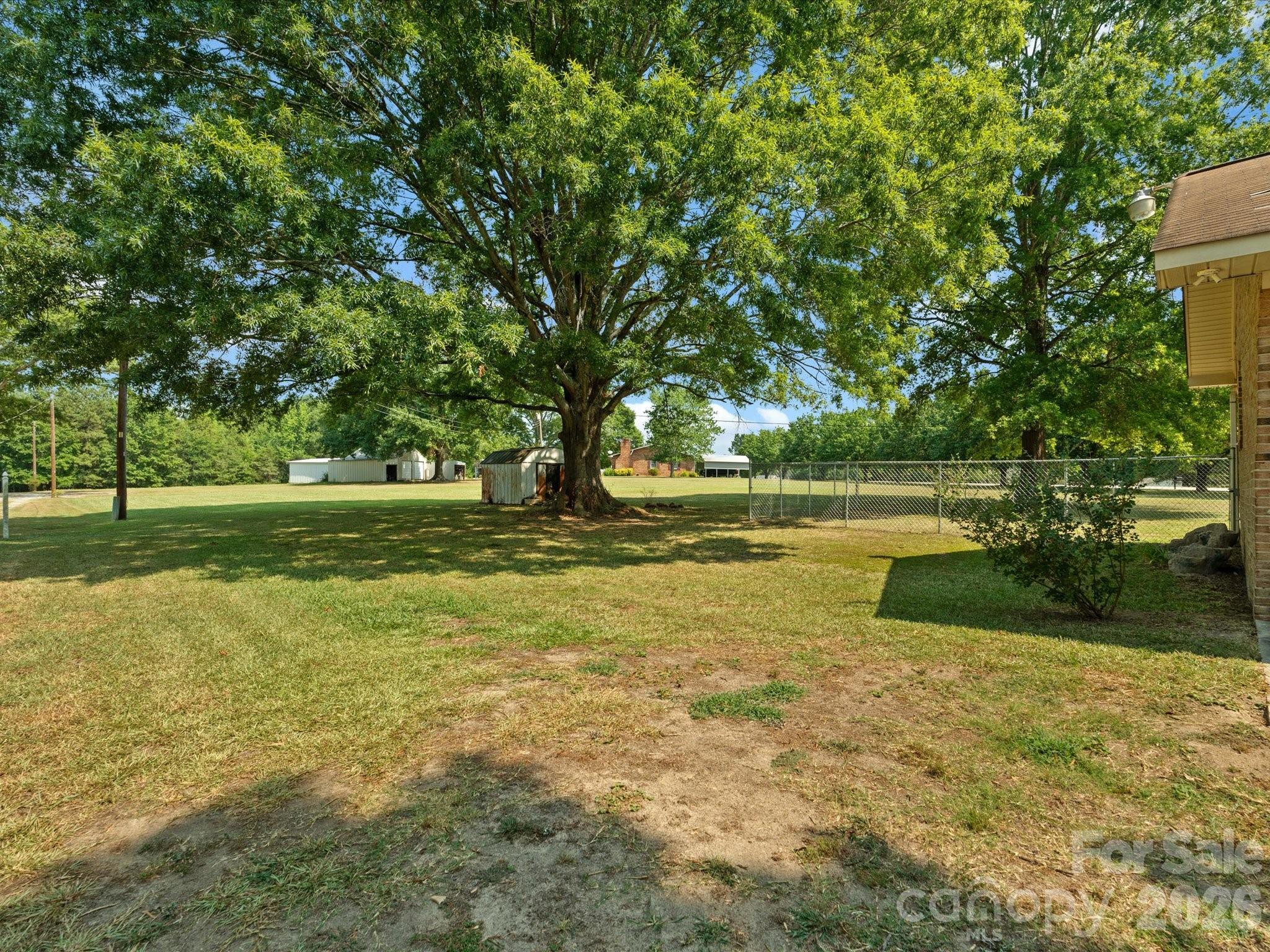 2212 J B Denton Road Lancaster, SC 29720 - Photo 33 of 38 a view of a swimming pool with a yard and large trees