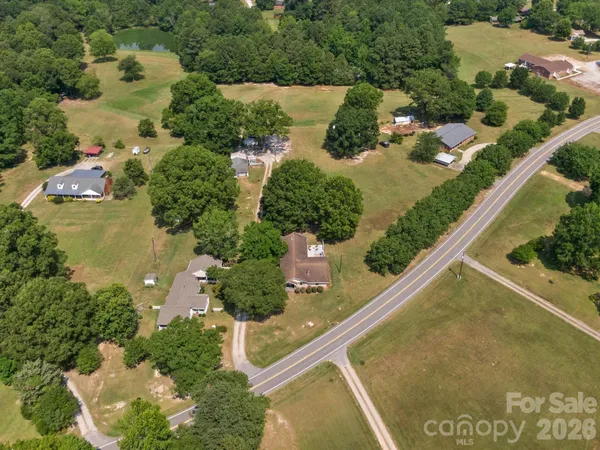 an aerial view of a house with a yard and lake view
