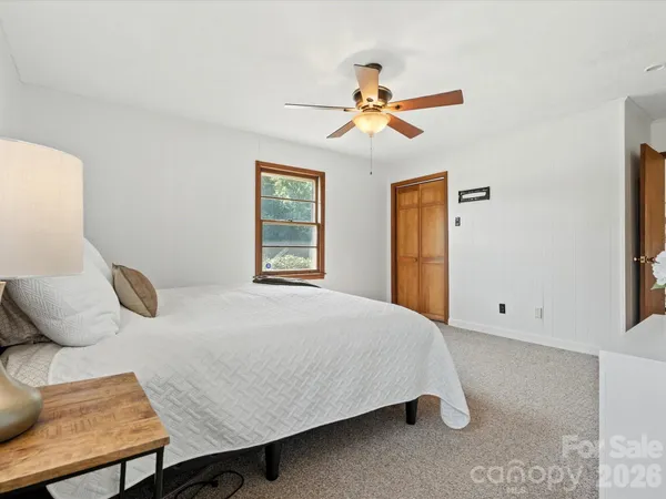 a bedroom with a bed and dresser