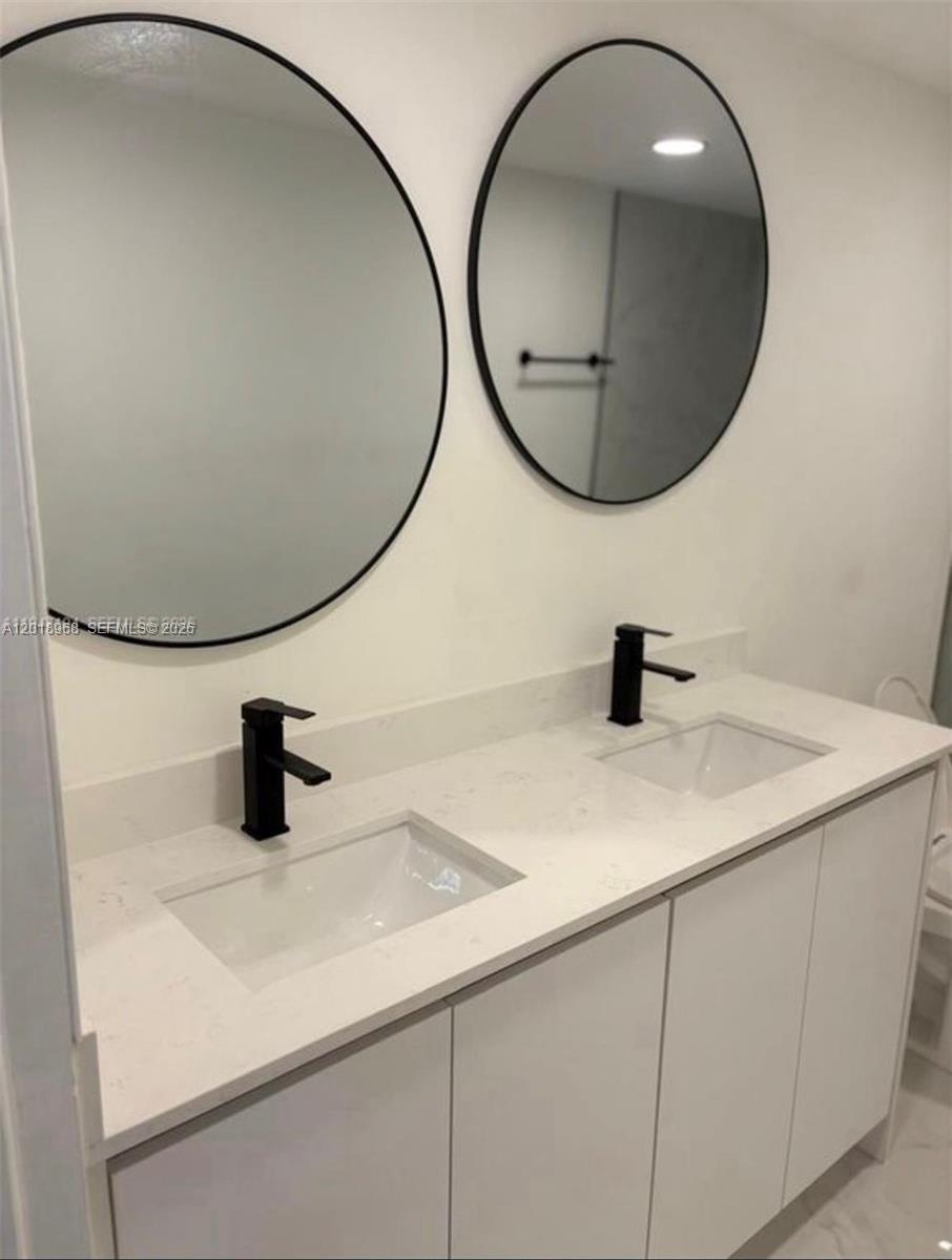 6104 Southwest 33rd Street Miramar, FL 33023 - Photo 12 of 18 a bathroom with a sink and a mirror
