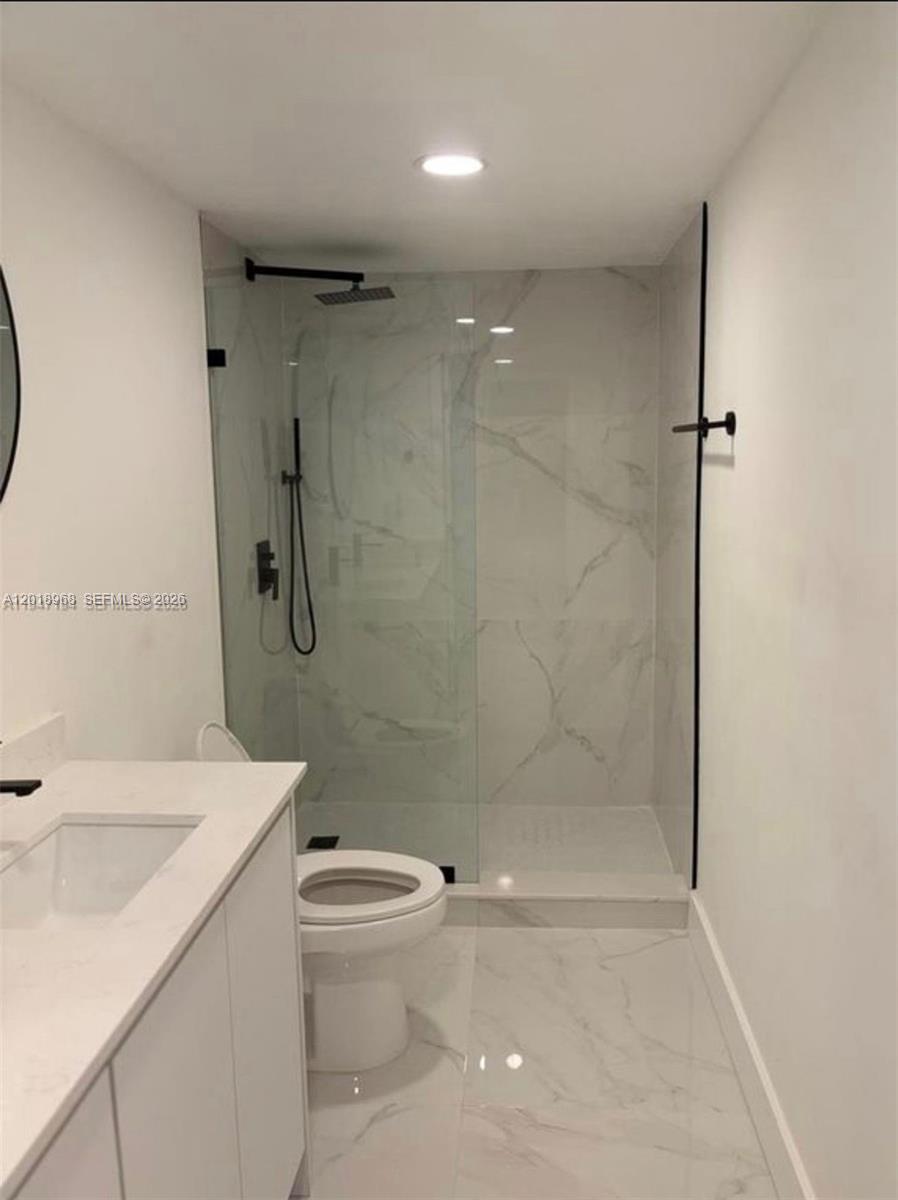 6104 Southwest 33rd Street Miramar, FL 33023 - Photo 13 of 18 a bathroom with a sink a toilet and shower