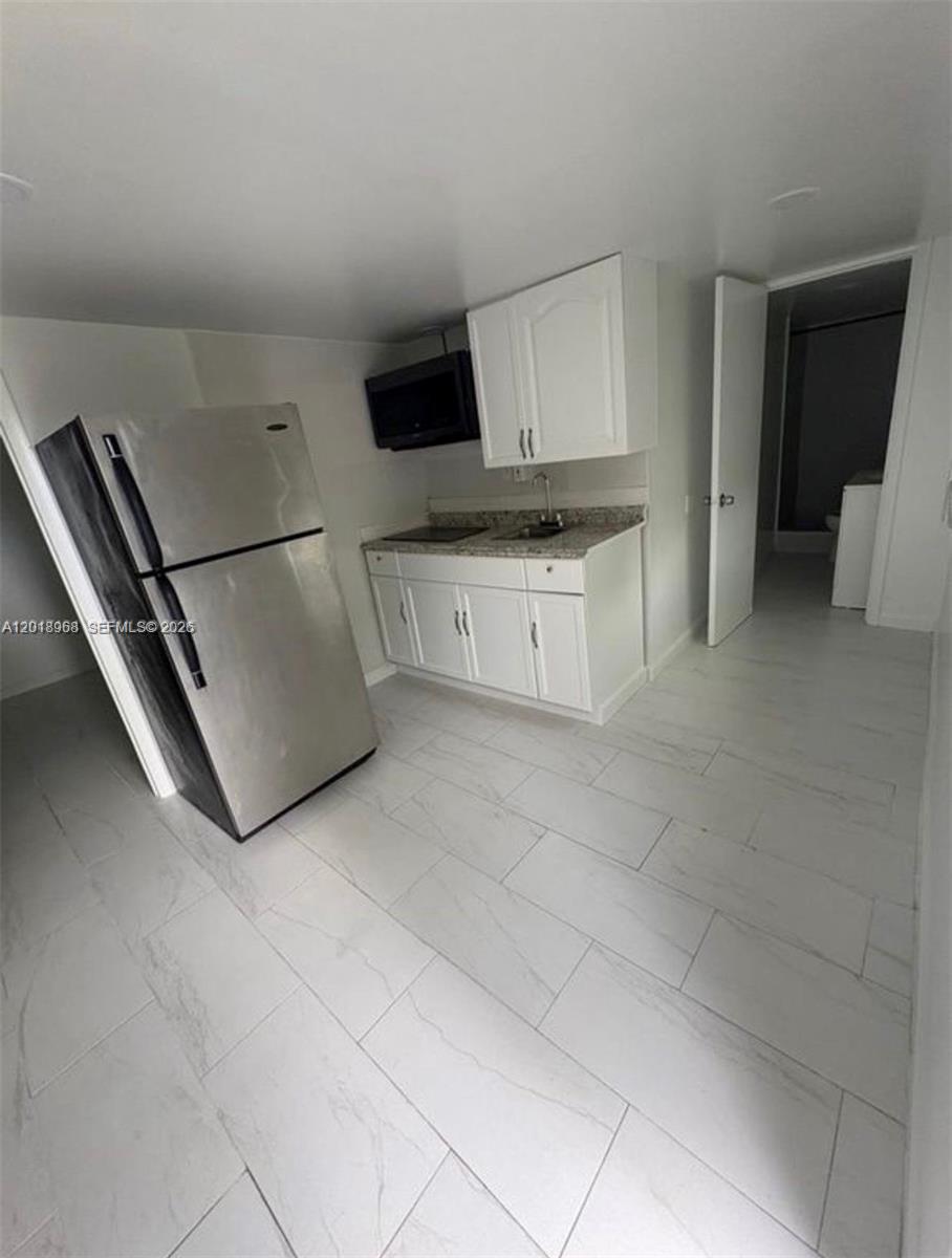6104 Southwest 33rd Street Miramar, FL 33023 - Photo 15 of 18 a kitchen with cabinets and white appliances
