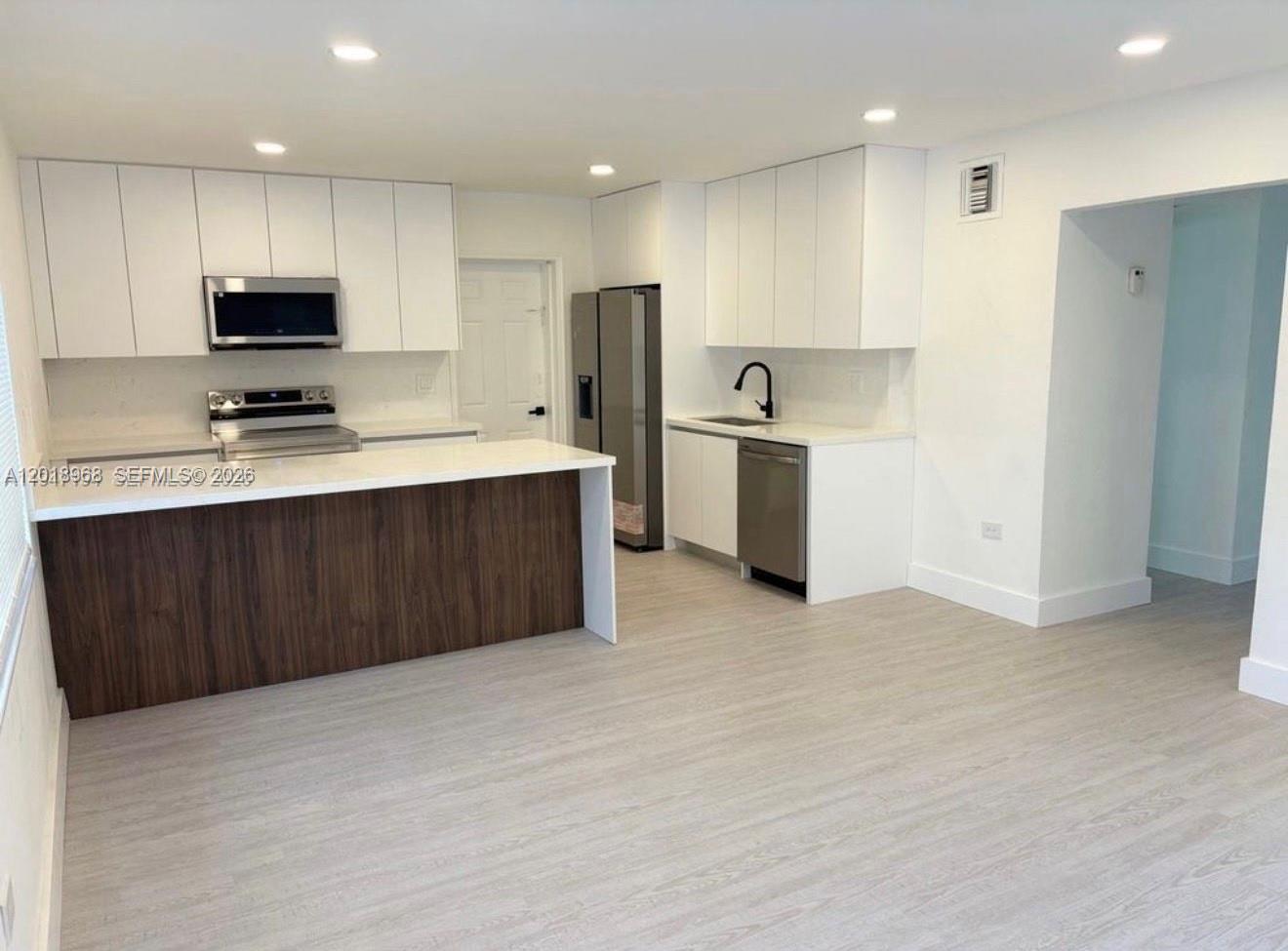 6104 Southwest 33rd Street Miramar, FL 33023 - Photo 4 of 18 a kitchen with stainless steel appliances a sink and a refrigerator