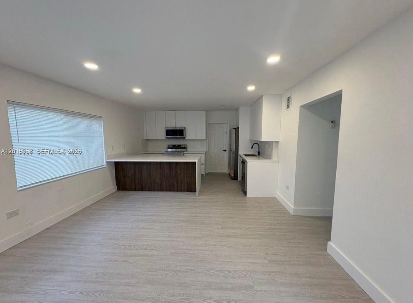 6104 Southwest 33rd Street Miramar, FL 33023 - Photo 5 of 18 a large kitchen with a refrigerator and a stove top oven