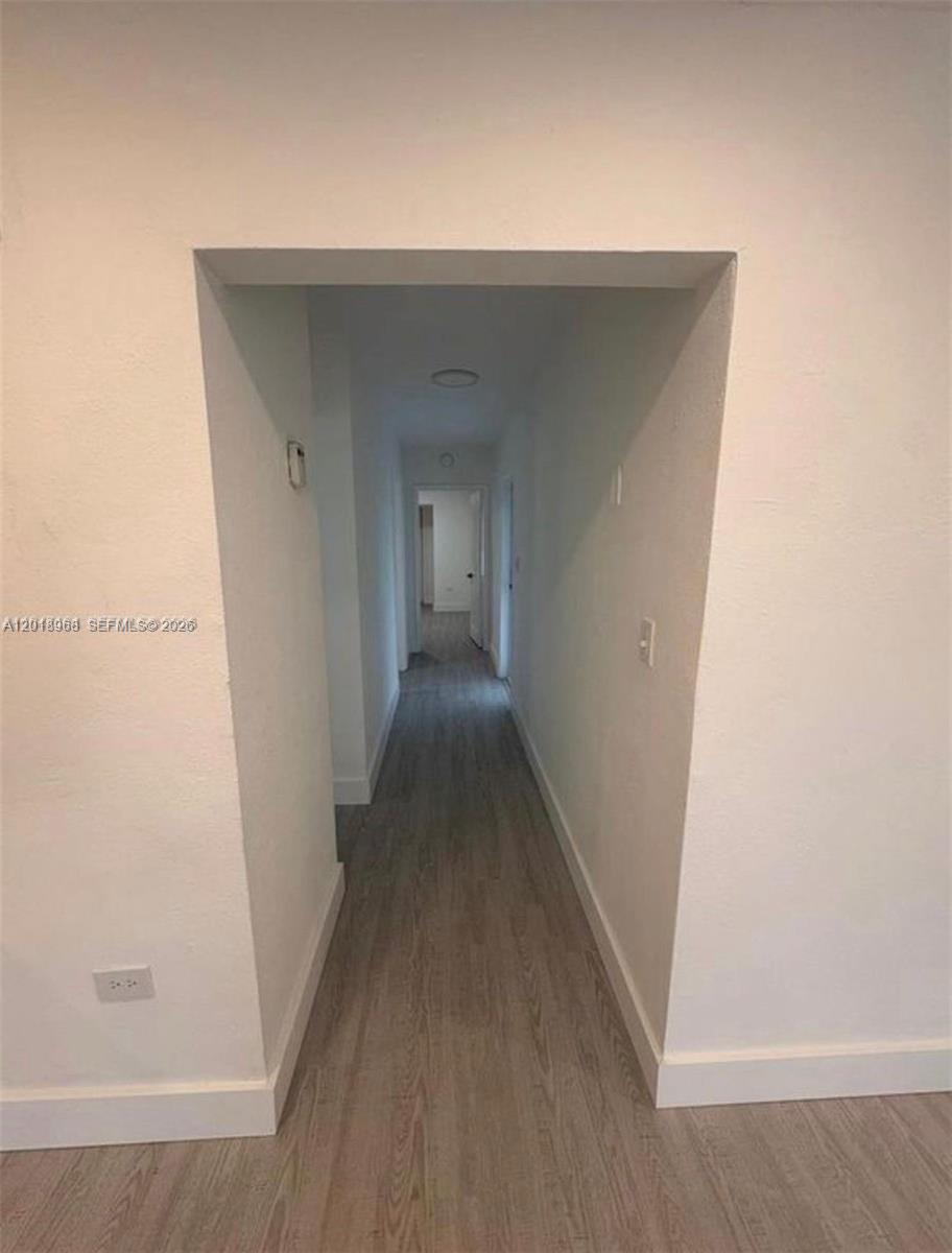 6104 Southwest 33rd Street Miramar, FL 33023 - Photo 6 of 18 a view of a hallway with wooden floor