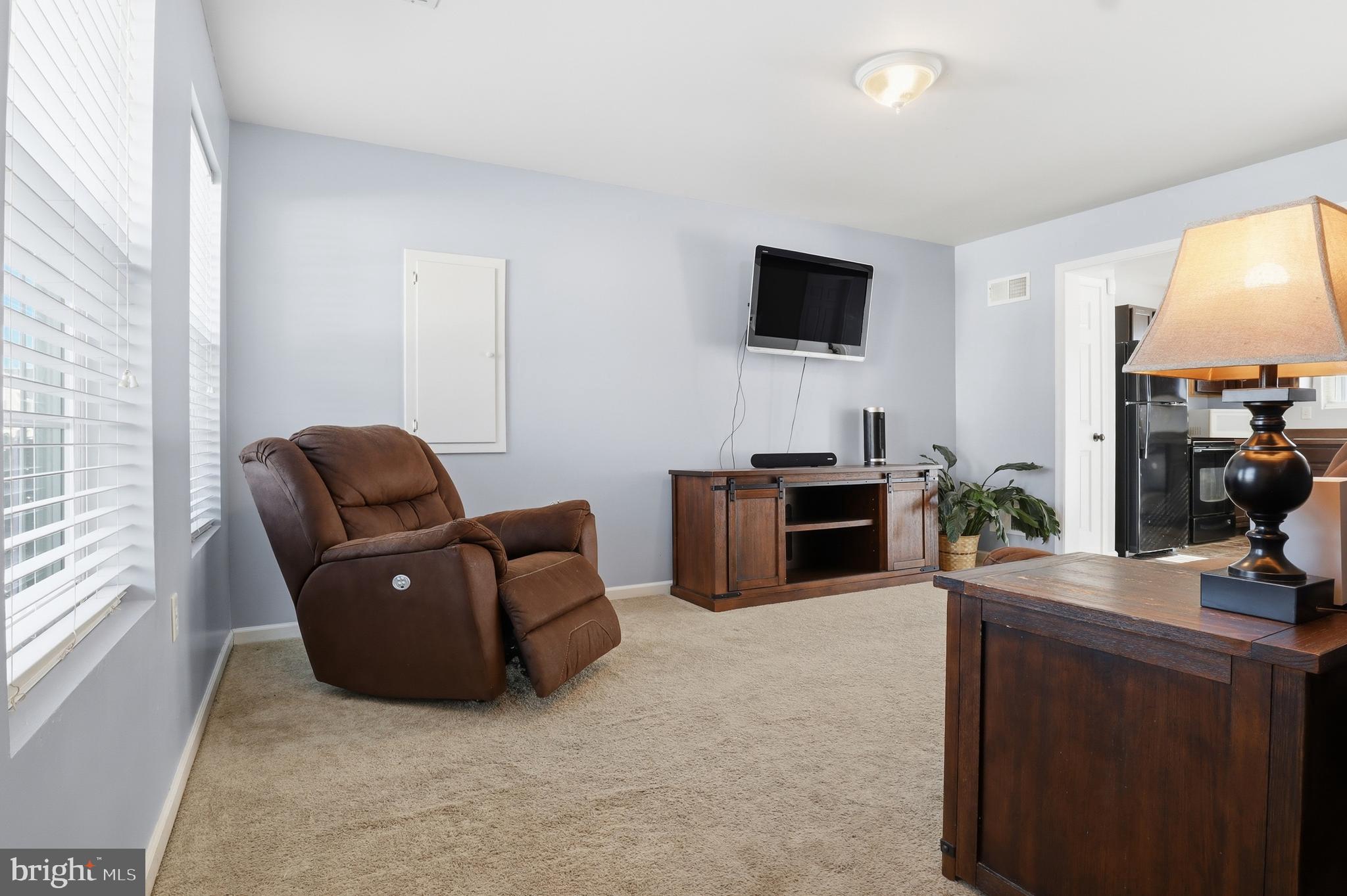 370 Azalea Drive Windsor, PA 17366 - Photo 6 of 40 a living room with furniture a flat screen tv and a fireplace