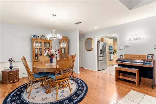 a view of a room with furniture and wooden floor