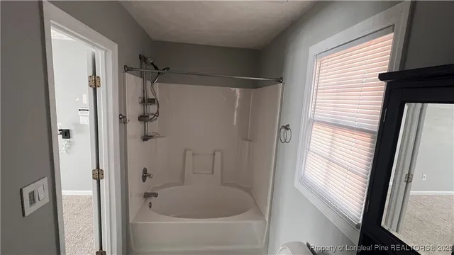 a bathroom with a shower and a sink