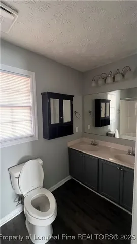 a bathroom with a toilet sink and mirror