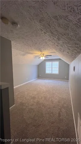 a view of a livingroom with a ceiling fan and window