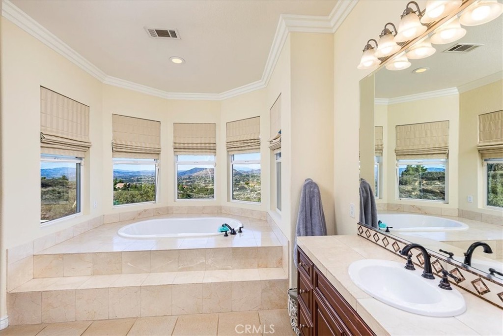 39110 Loren Way Temecula, CA 92592 - Photo 13 of 42 a spacious bathroom with a bathtub and a sink
