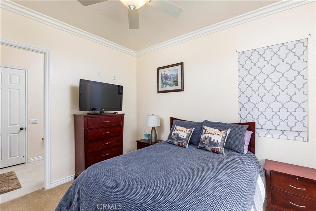 39110 Loren Way Temecula, CA 92592 - Photo 16 of 42 a bedroom with a bed and a flat tv screen on dresser