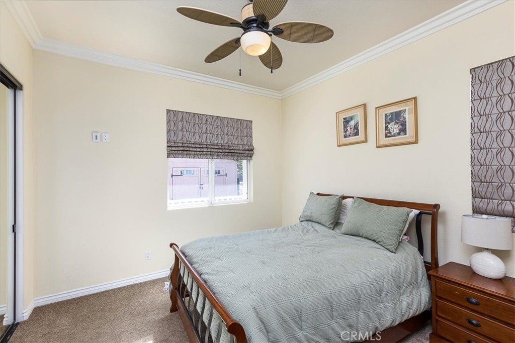 39110 Loren Way Temecula, CA 92592 - Photo 19 of 42 a bedroom with a bed and a chandelier