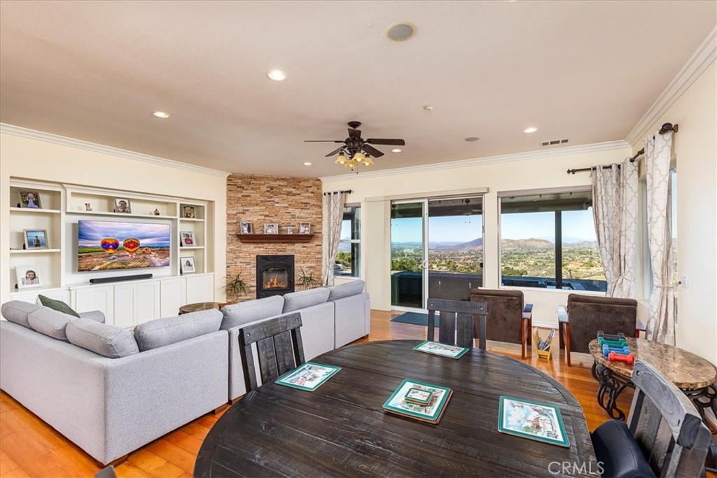 39110 Loren Way Temecula, CA 92592 - Photo 6 of 42 a living room with furniture a fireplace and a flat screen tv