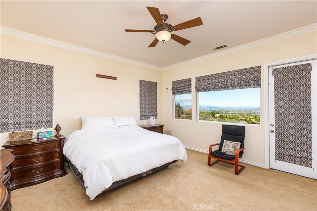 39110 Loren Way Temecula, CA 92592 - Photo 10 of 42 a bedroom with a bed a chair and a large window